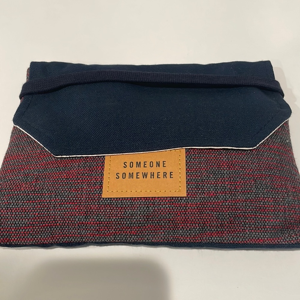 Delta One Someone Somewhere Artisan-Made Amenity Kit. Red, grey and blue. NWT